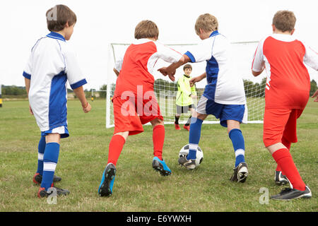 Junior 5 a side teams playing football Stock Photo