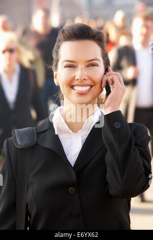Female commuter talking on phone Stock Photo