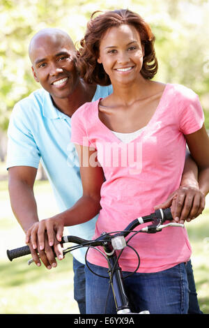 Young  couple cycling in park Stock Photo