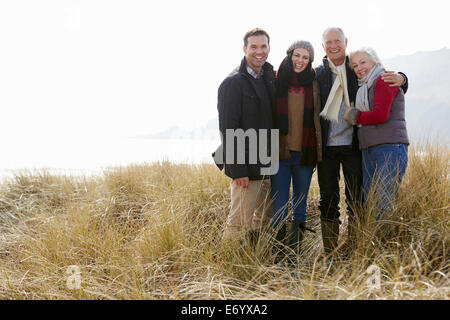Parents With Adult Offspring Standing In Dunes Stock Photo