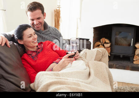 Couple Relaxing At Home Drinking Wine Stock Photo