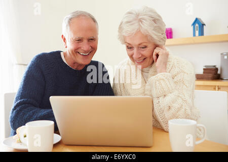 Senior Couple Using Laptop To Shop Online Stock Photo