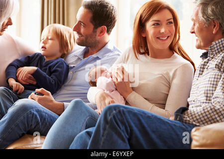 Couple On Roof Terrace Using Laptop And Digital Tablet Stock Photo