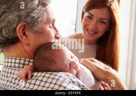 Young Man Relaxing On Sofa Using Digital Tablet Stock Photo