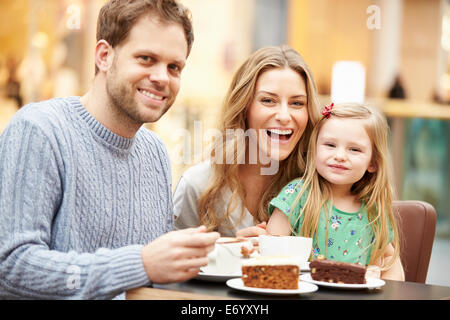 Family Enjoying Snack In Café Together Stock Photo