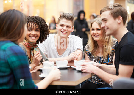 Group Of Young Friends Meeting In Café Stock Photo