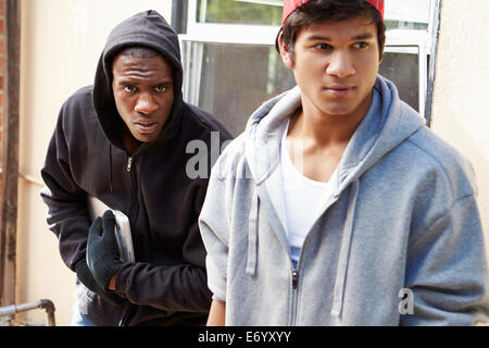 Two Young Men Breaking Into House And Stealing Laptop Stock Photo