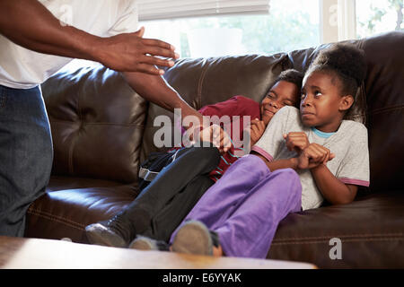 Father Being Physically Abusive Towards Children At Home Stock Photo