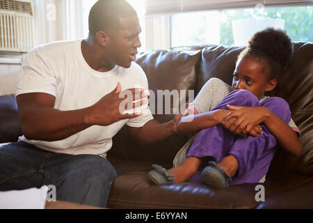 Father Being Physically Abusive Towards Daughter At Home Stock Photo