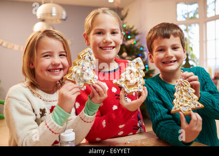 Three Children Showing Decorated Christmas Cookies Stock Photo