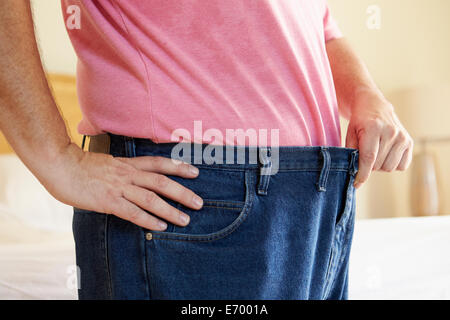 Close Up Of Man On Diet Losing Weight From Waist Stock Photo