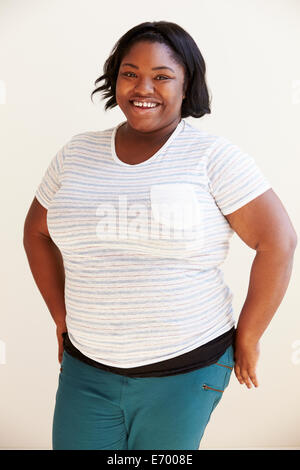 Studio Portrait Of Smiling Overweight Woman Stock Photo