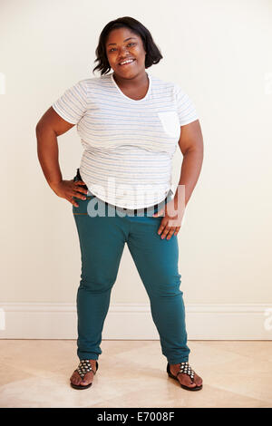 Studio portrait of Plus size african confident female model in white shirt  and jeans, looking at camera posing isolated over white background Stock  Photo - Alamy