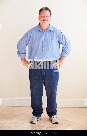 Studio Portrait Of Smiling Overweight Man Stock Photo