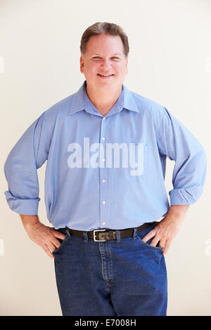 Studio Portrait Of Smiling Overweight Man Stock Photo