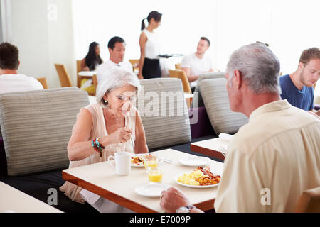 Senior Couple Enjoying Breakfast In Hotel Restaurant Stock Photo