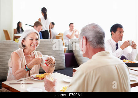 Senior Couple Enjoying Breakfast In Hotel Restaurant Stock Photo