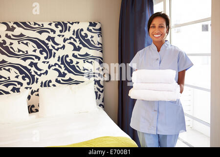 Portrait Of Maid Tidying Hotel Room Stock Photo