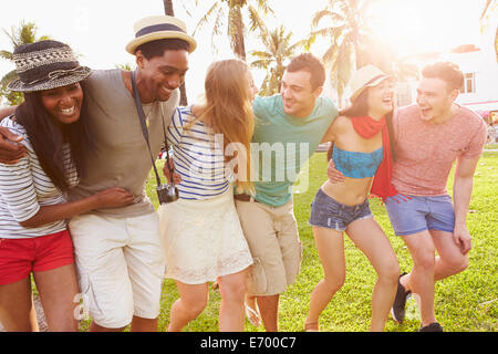 Group Of Friends Having Fun In Park Together Stock Photo