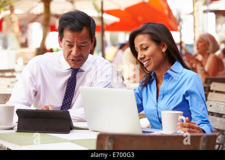 Two Businesspeople Having Meeting In Outdoor Café Stock Photo