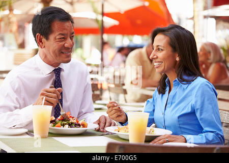 Two Businesspeople Having Meeting In Outdoor Restaurant Stock Photo