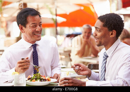 Two Businessmen Having Meeting In Outdoor Restaurant Stock Photo