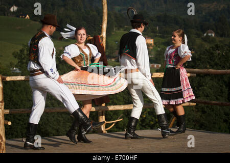 Czech folklore dancers, wearing traditional costume, performing traditional dance on stage in Beskidy mountains. Stock Photo