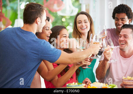 Group Of Friends Enjoying Drinks Party At Home Stock Photo