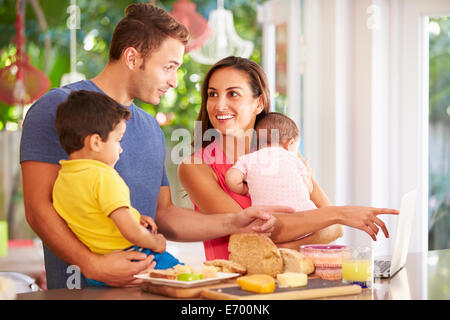 Mother Making Snack For Family In Kitchen Stock Photo