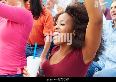 Woman In Crowd Celebrating At Sports Event Stock Photo