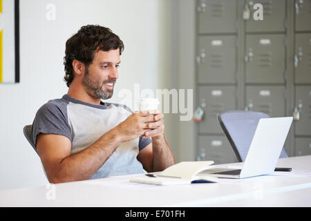 Casually Dressed Man Working In Design Studio Stock Photo