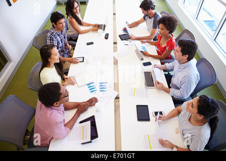 Overhead View Of Designers Meeting To Discuss New Ideas Stock Photo
