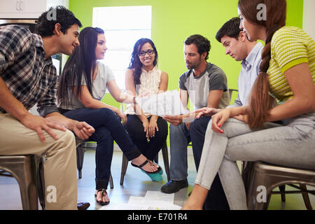 Group Of Hispanic Designers Meeting To Discuss New Ideas Stock Photo