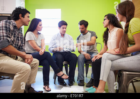 Group Of Hispanic Designers Meeting To Discuss New Ideas Stock Photo