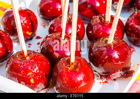Caramelized Red Apples On White Wooden Sticks Stock Photo