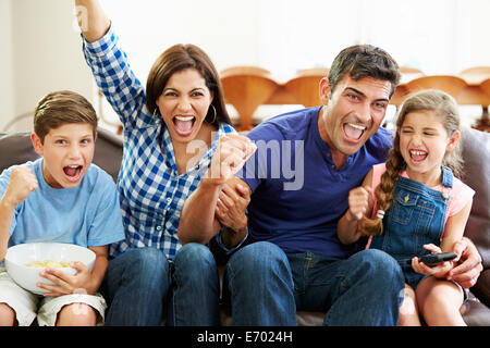 Family Watching Soccer Celebrating Goal Stock Photo