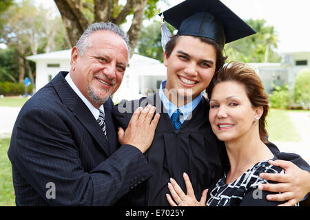 Hispanic Student And Parents Celebrate Graduation Stock Photo