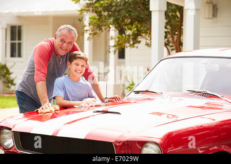 Grandfather And Grandson Cleaning Restored Classic Car Stock Photo