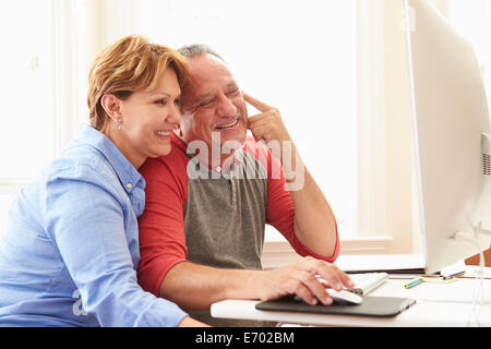 Senior Couple Using Computer At Home Stock Photo
