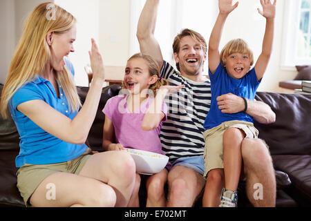 Family Watching Soccer on TV Celebrating Goal Stock Photo