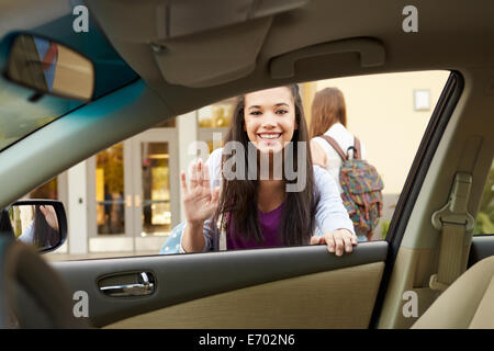 Female High School Student Being Dropped At School By Parent Stock Photo