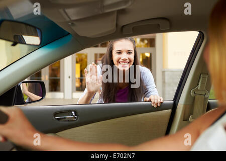 Female High School Student Being Dropped At School By Parent Stock Photo