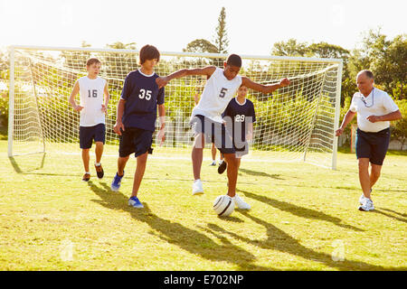 Members Of Male High School Soccer Playing Match Stock Photo