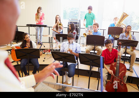 Pupils Playing Musical Instruments In School Orchestra Stock Photo