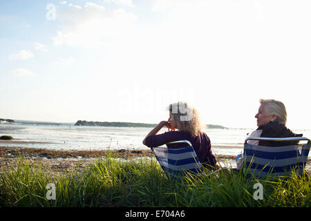 Mother and daughter enjoying view on beach Stock Photo