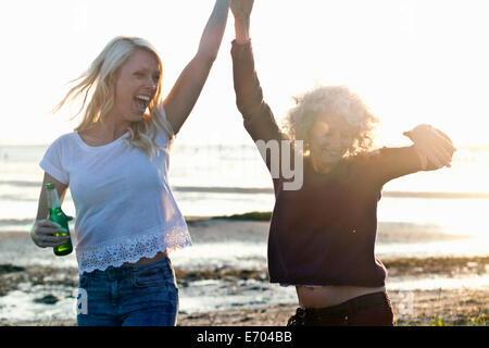 Mother and daughter dancing on Bournemouth beach, Dorset, UK Stock Photo