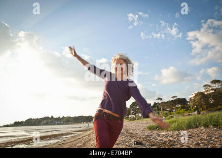 Mature woman enjoying beach Stock Photo