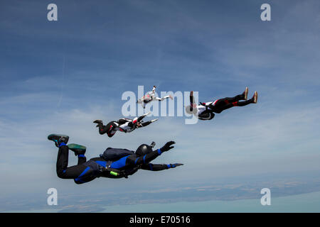 Four young adult male skydivers free falling, Siofok, Somogy, Hungary Stock Photo