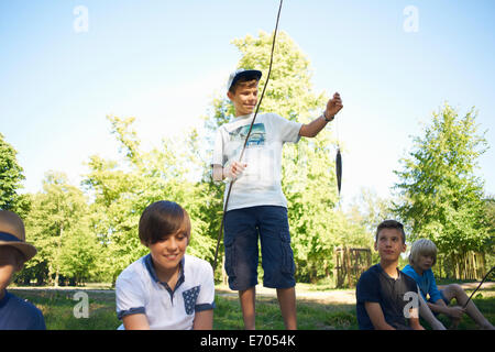 Boy holding fishing net with fish Stock Photo