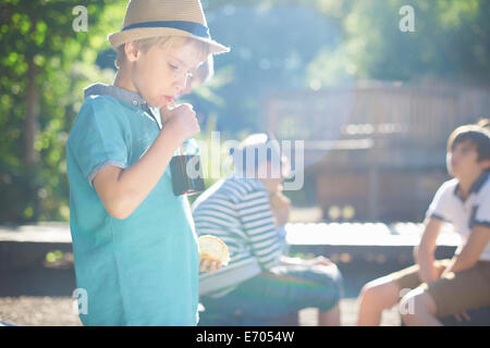 Young boy having lunch in park Stock Photo